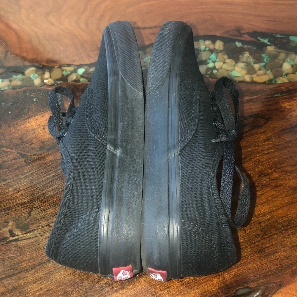 Vans all black kids lace up skateboard shoes.
